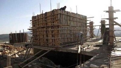 Palestinian-Workers-construct-new-houses-via-AFP.jpg